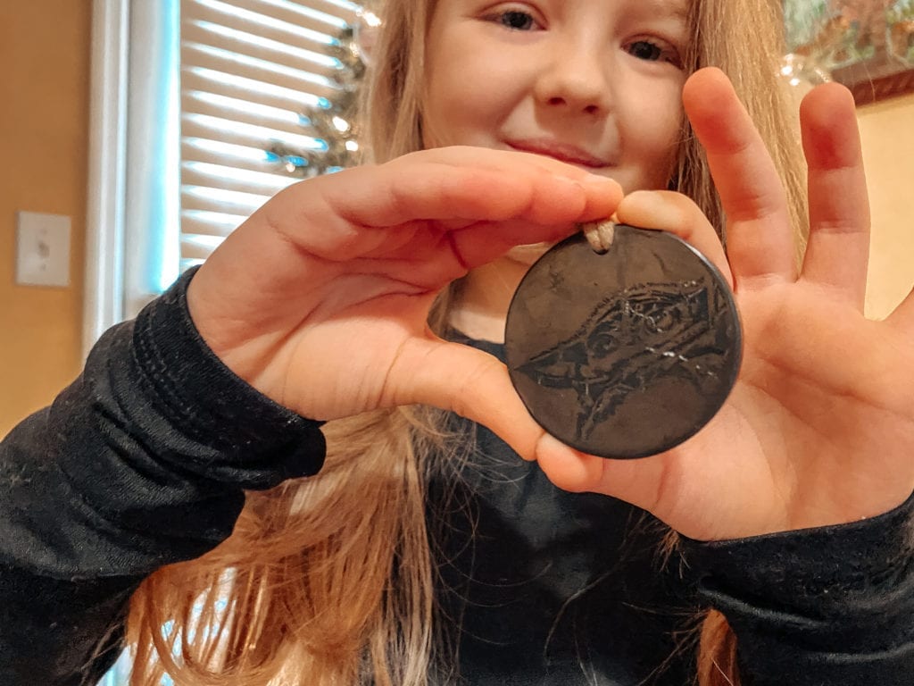 child wearing baby yoda necklace